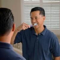 man brushing his teeth