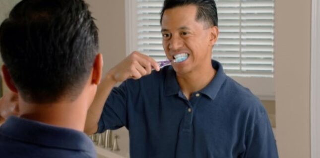 man brushing his teeth