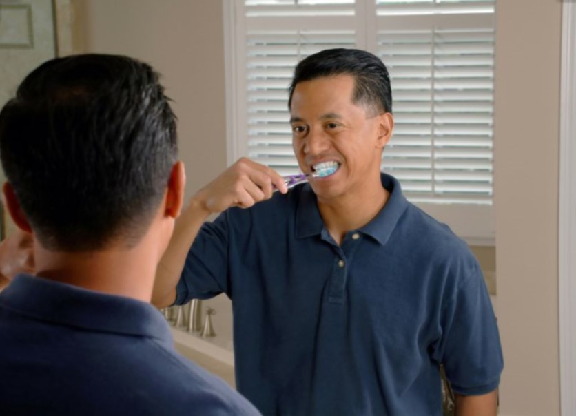 man brushing his teeth