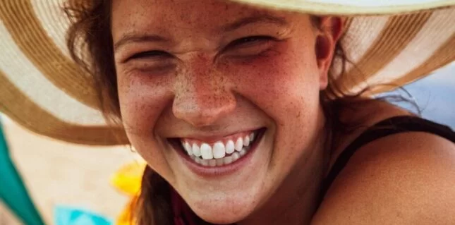 women smiling in a sun hat